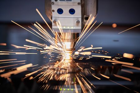 Laser cutting. Metal machining with sparks on CNC laser engraving machingの写真素材