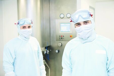 Portrait of two workers  at pharmaceutical factoryの写真素材