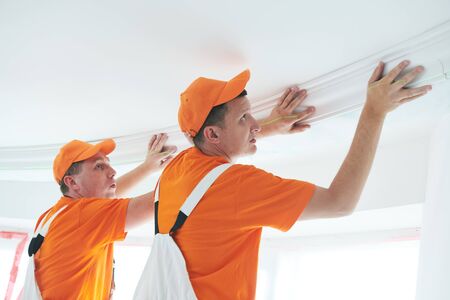 installing decorative ceiling molding. home repair and decorationの写真素材