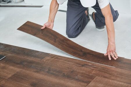 worker joining vinyl floor covering at home renovationの写真素材