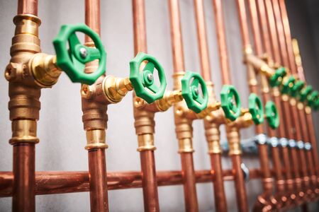 Plumbing service. copper pipeline of in boiler room. valves in row