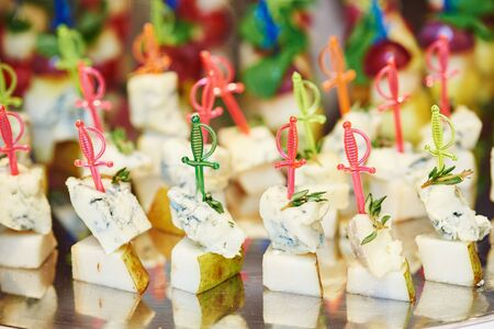 Catering food service. little cheese snack and appetizer on table at food court table during event partyの写真素材