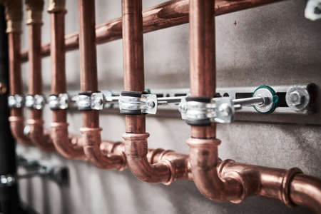 Plumbing service. copper pipeline of a heating system in boiler roomの写真素材
