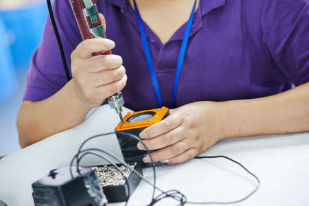 female worker in assembling electronic device on factoryの写真素材