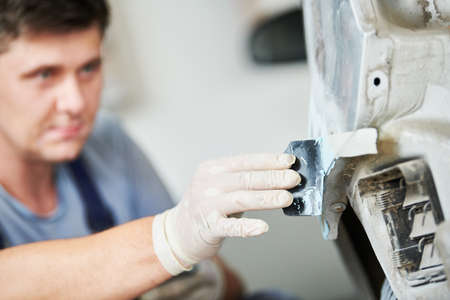 auto repairman plastering autobody bonnetの写真素材