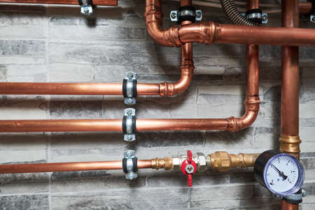 Plumbing service. copper pipeline of a heating system in boiler roomの写真素材