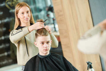 Haircut of young man. Hairdressing at barber shopの写真素材