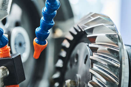 Spiral gear milling machine work. CNC grinding machine in metalwork industryの写真素材