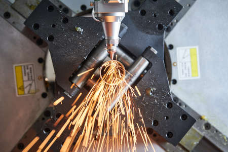 Fiber laser tube cutting machine. metal pipe cutting with sparks