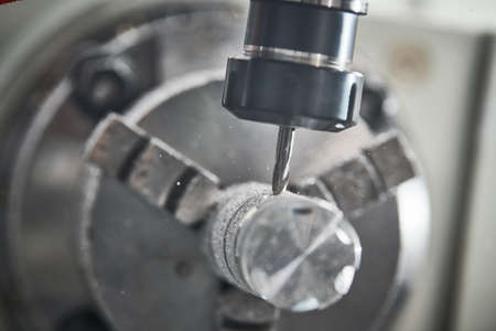 Precision machining metal detail on CNC milling machineの写真素材