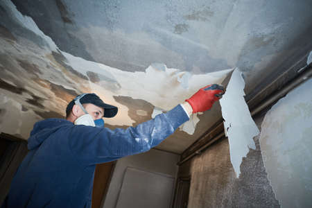 fire damage and restoration indoor interior. removing damaged paint layerの写真素材