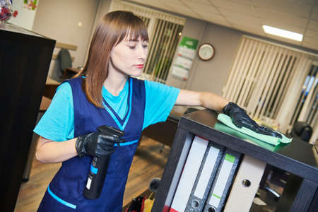 cleaning service. wiping office furniture with cloth