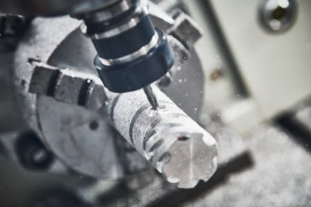 Precision machining metal detail on CNC milling machineの写真素材