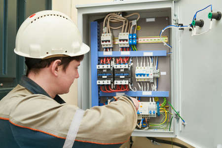 Electrician work. Installing equipment in switchbox. current breaker installation