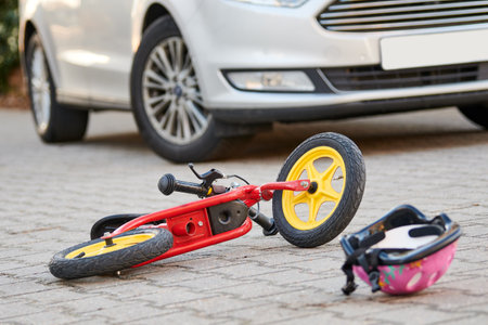 child bicycling helmet and bicycle near car during collision accident in the cityの写真素材