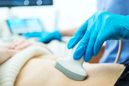 Medical ultrasound imaging and scan. Examining stomach of female patient