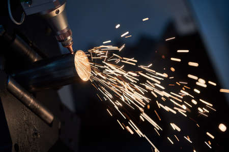Fiber laser tube cutting machine. metal pipe cutting with sparksの写真素材