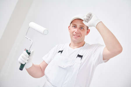 Painter worker portrait with roller paintingの写真素材