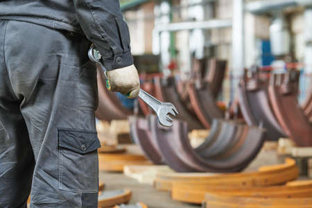 industrial equipment service and maintenance. worker with wrench in hand