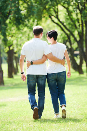 Young adult people walking throuth summer park. Dating conceptの写真素材