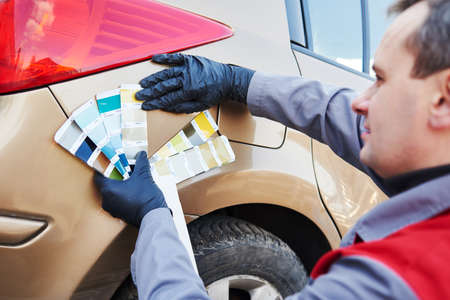 colourist man selecting color of car with paint matching samplesの写真素材