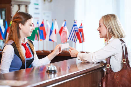 Reception front desk at hotel. Worker and guestの写真素材