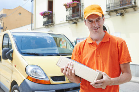 delivery man with package outdoors. Shipping servicesの写真素材
