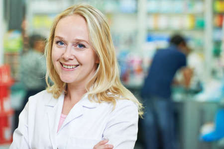 female pharmaceutical worker portrait in drugstoreの写真素材