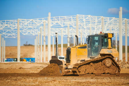 earth mover bulldozer at construction site during buildingの写真素材