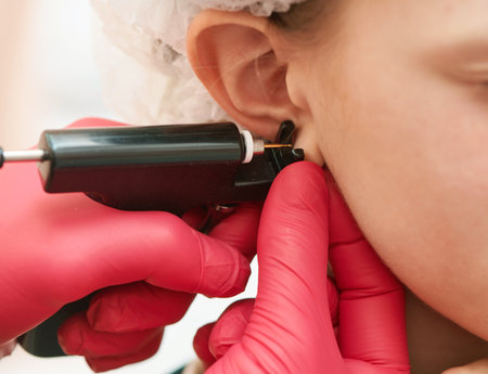 little girl during an ear piercingの写真素材