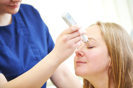 doctor measure eye pressure from female patientの写真素材