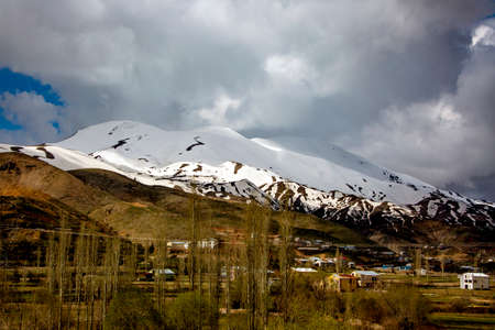 snowy mountain and green filed in turkey