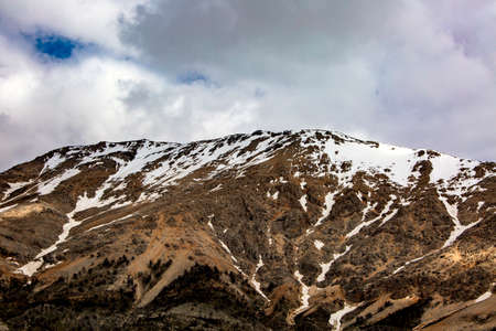 snowy mountain and green filed in turkey