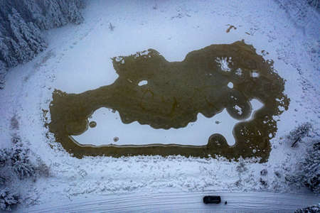 Snow-covered forest air of the mountains, snow, sea and stream coastの写真素材