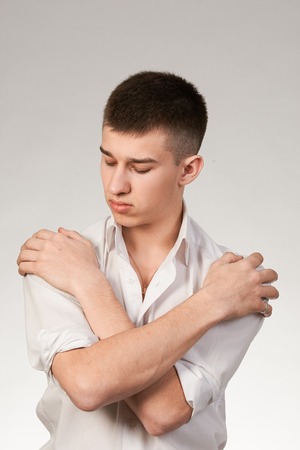 Portrait of young man standing  isolated on white backgroundの写真素材
