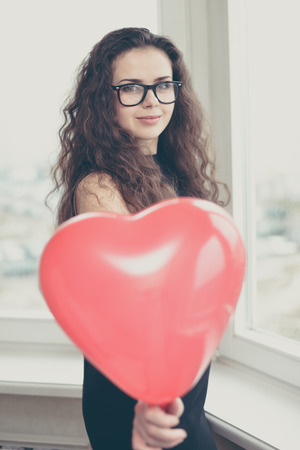 Attractive caucasian woman holding a baloon heart.の写真素材