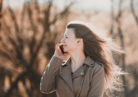 Girl a talking on the phone in the parkの写真素材