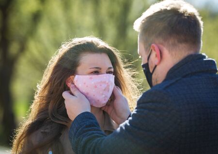 The guy adjusts the protective mask to the girl