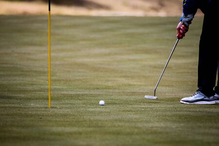Play the golf hole on the greenの写真素材