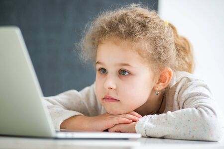 Girl sitting at a laptop at home