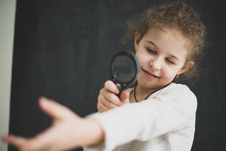 girl studying objects with a magnifierの写真素材
