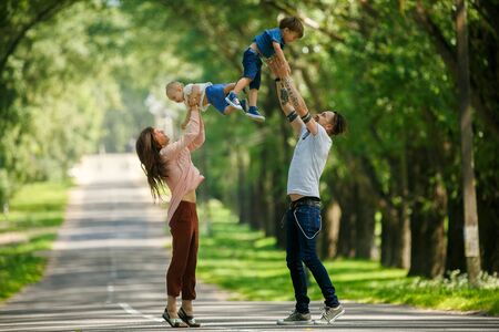 parents play with children in the parkの写真素材