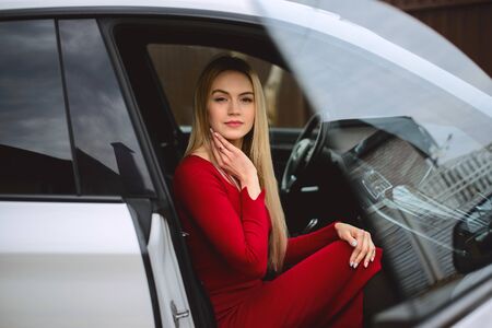 The Girl in red dress in car