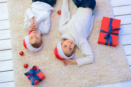 The boy and girl in Christmas with giftsの写真素材