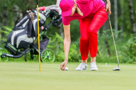 Golfer playing with club on the fieldの写真素材