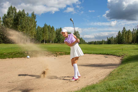 Golfer hold the ball to hand before hittingの写真素材