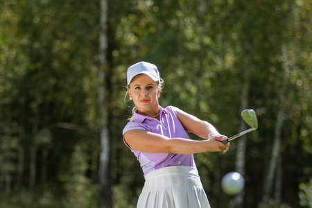 Golfer hits with a club during the tournamentの写真素材