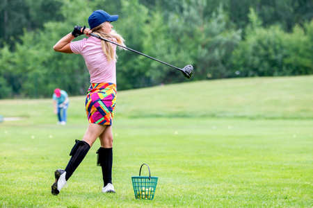 Golfer hits with a club during the tournament
