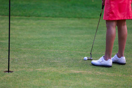The Girl golfer prepare for hitting iron during golf workout