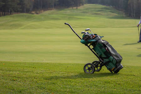 Golf course with a bag of clubs on the fairwayの写真素材